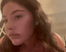a close up of a woman 's face with a sad look on her face