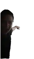 a man in a black shirt is pointing at the camera