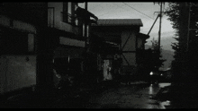 a black and white photo of a street with a sign that says ' a '