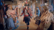 a woman in a pirate costume is walking in front of a sign that says apple