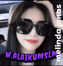 a woman wearing sunglasses with the words w.alaikumslm behind her