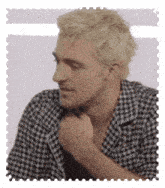 a man with blonde hair is wearing a black and white shirt