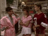 a group of women are standing next to each other in a living room .
