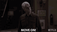 a man in a brown shirt says move on