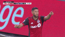 a soccer player in a red jersey with bmo on the front
