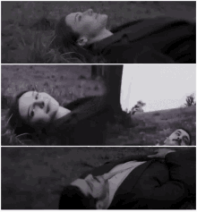 a black and white photo of a man and a woman laying on the ground