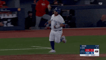 a baseball player wearing a blue jays jersey is running towards a base
