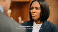 a woman in a suit talks to a man and says " you can 't remove him from us "