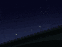 a group of people standing on a bridge watching fireworks