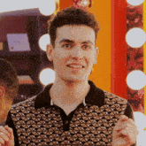 a man wearing a polo shirt with a geometric pattern on it