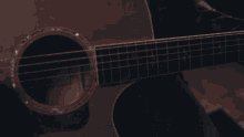 a man singing into a microphone while playing a guitar