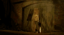 a man carrying a woman in his arms in a tunnel