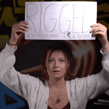a woman holds up a piece of paper that says rigged