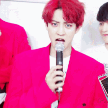 a man with red hair is holding a microphone