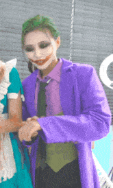 a woman in a joker costume is standing next to a maid in a blue dress