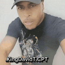 a man wearing a hat and a t-shirt that says king davidt cpt