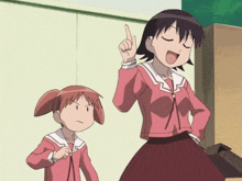 a girl in a pink shirt is pointing up while another girl looks angry