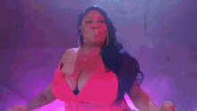 a woman in a red dress is dancing in front of a blue light .