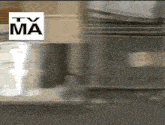 a tv ma logo is above a blurred image of a kitchen