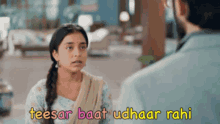 a woman is talking to a man with the words teesar baat udhaar rahi written above her