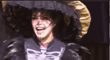 a woman in a skeleton costume is laughing on a stage