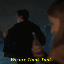 a man in a dark room with the words we are think tank on the bottom