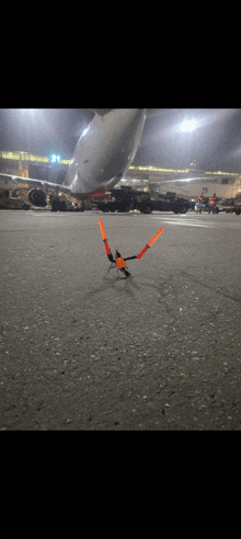 a plane is parked on the tarmac at an airport with a bird sitting on the ground