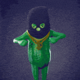 a green frog wearing a ski mask and gold chain