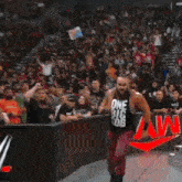 a wrestler is being lifted in the air by another wrestler during a match .