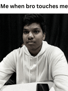 a black and white photo of a young man with the caption " me when bro touches me "