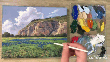a person is painting a landscape with a palette in the background that says made in animonica