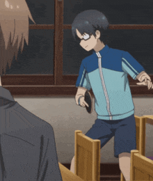 a boy with glasses is playing ping pong in a room
