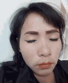 a close up of a woman 's face with a serious look on her face