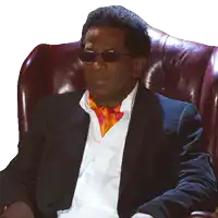 a man wearing sunglasses sits in a chair