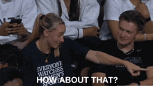 a woman wearing a shirt that says " everyone watches women 's sports "