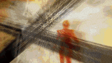 a blurred image of a person standing in a room