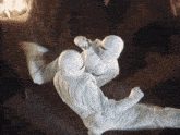 a man in a white suit is jumping in the air