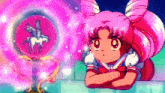 a little girl with pink hair is looking at a pink object with a unicorn on it .