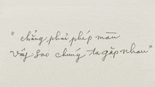 a piece of paper with a handwritten phrase in a foreign language