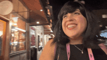 a woman wearing a black shirt and a lanyard that says ' u.s. polo ' on it