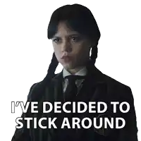 a girl in a suit and tie has the words i 've decided to stick around above her