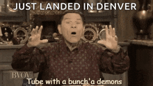 a man is making a funny face with the words just landed in denver tube with a bunch a demons