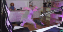 a woman is dancing in a room in front of a microphone .