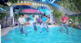a group of young men dancing in front of a sign that says love language