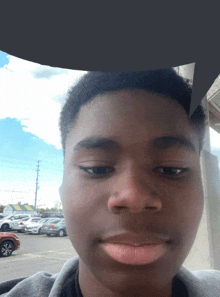 a close up of a young man 's face with a speech bubble behind him