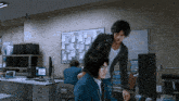 a man standing next to a woman in an office