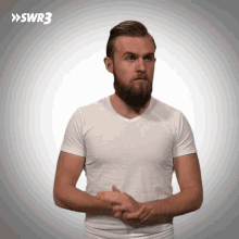 a man with a beard wearing a white t-shirt with swr3 written on the bottom