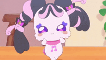 a pink and black cartoon character with a music note on her chest
