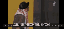 a screen shows a man wearing a hat and a scarf with the words ne ne nechtel bych