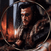 a man with long hair and a beard is surrounded by a circle